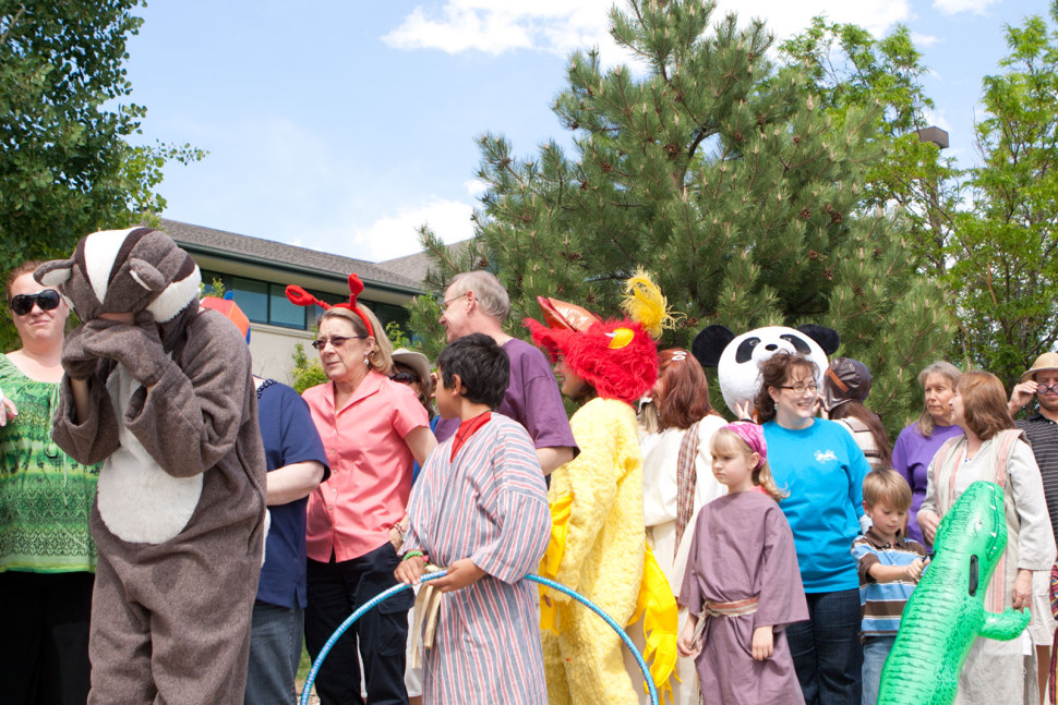 A line of kids and adults in crazy VBS attire look impatient as they stand in a long registration line